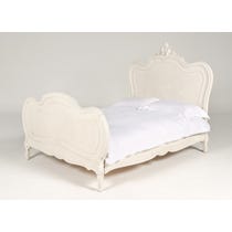 Decoratively carved off white bed