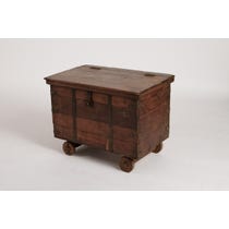 Dark wood chest on wheels